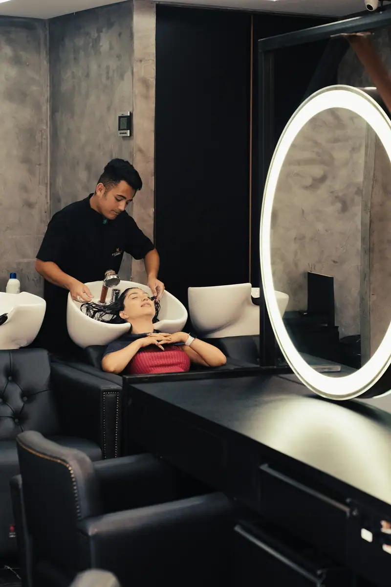 Salon lounge with a wash station and a ring-light mirror