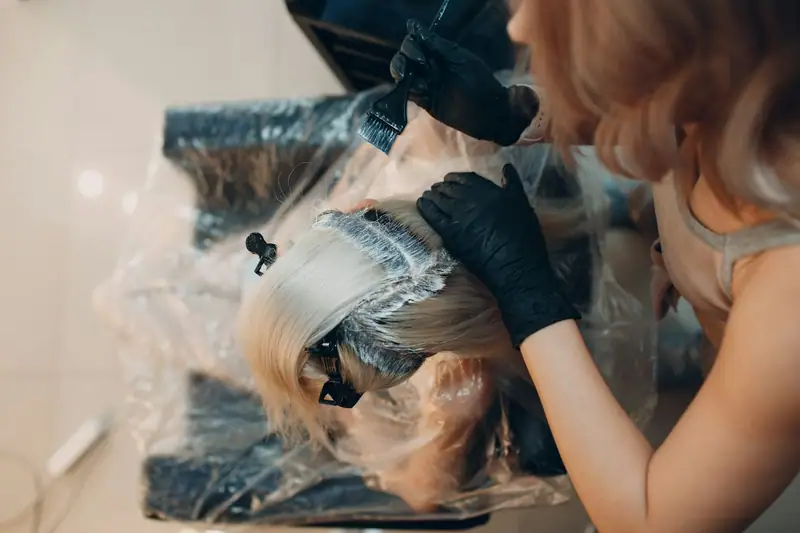 Foils being applied to hair in a salon