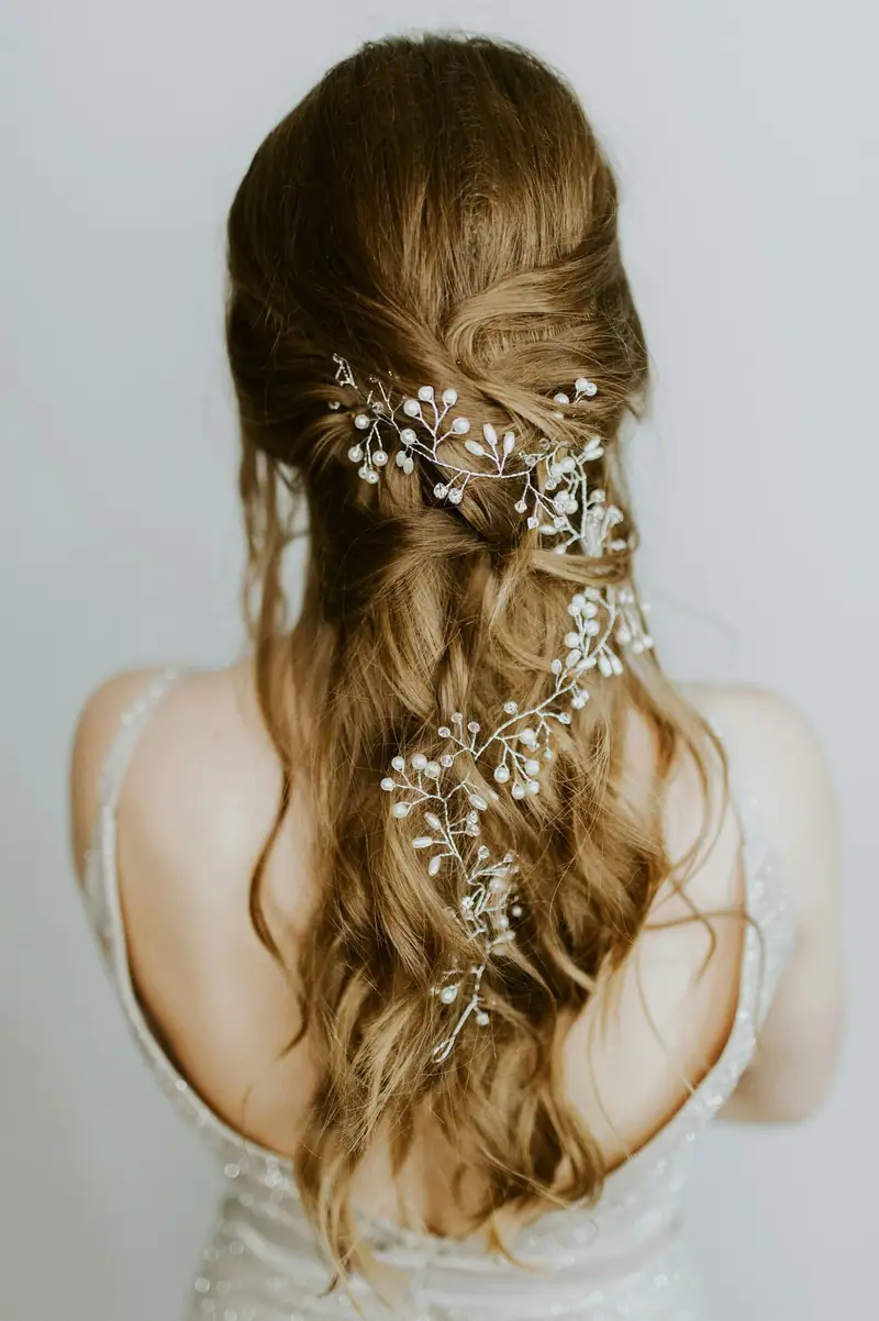 Bridal half-up style with pearl hair pins, from behind